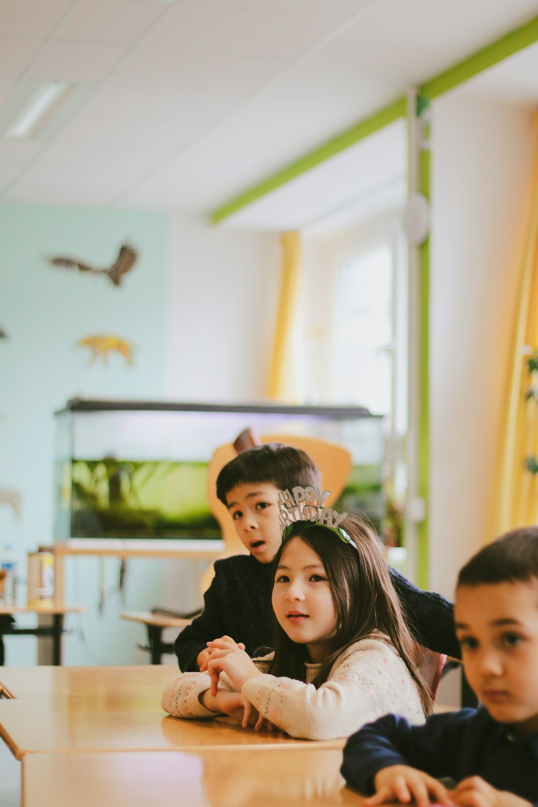 a-group-of-children-sitting-at-a-table-79luoxzgdci