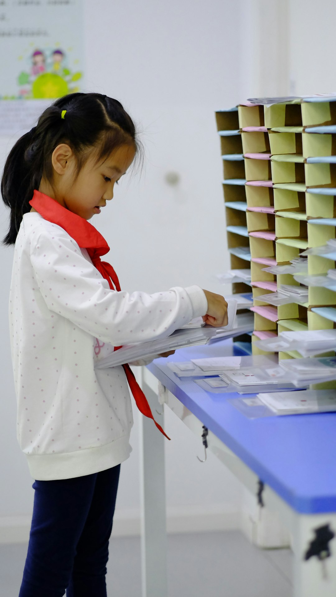 a-little-girl-standing-in-front-of-a-table-with-a-bunch-of-papers-on-it-t9qu2vib2-m